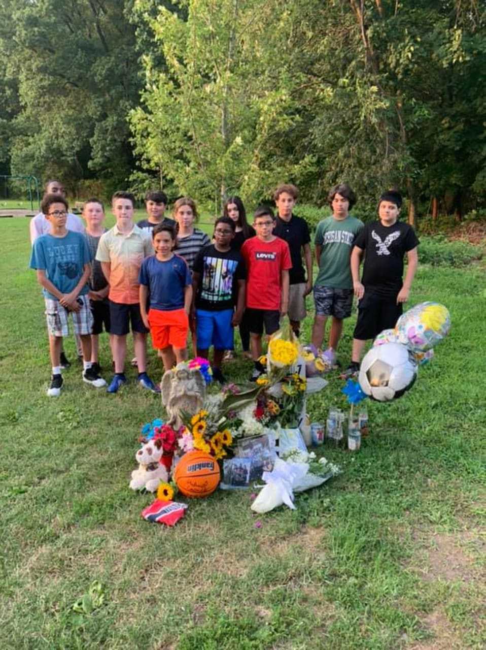Children in Union meet at a makeshift memorial for Jeremy Maraj