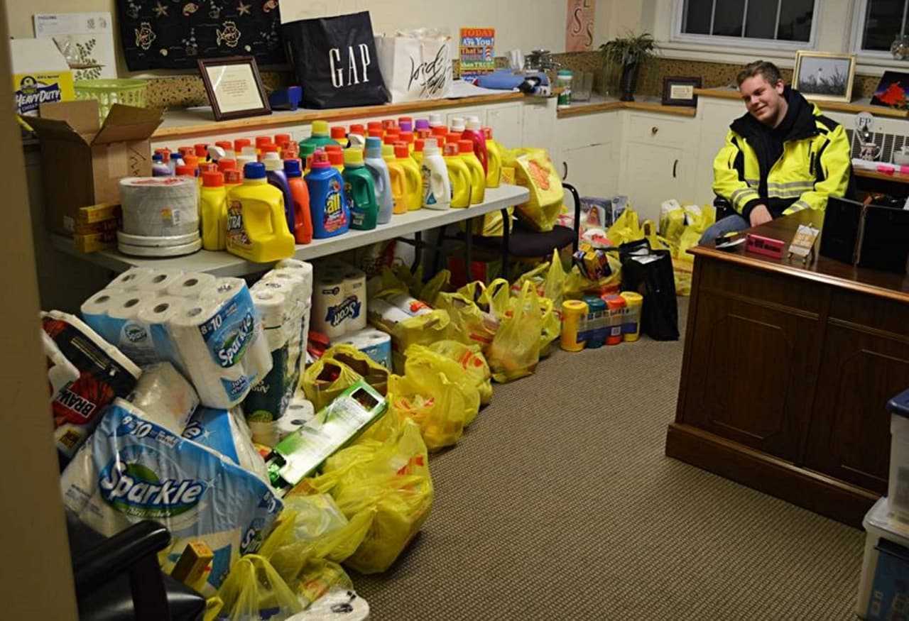 A Norwood EMS member sits next to part of the organization's haul of donations.