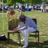 Karl Scott adorns a chair with wild grasses at last year's Art in the Park in Piermont.