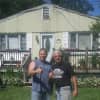 Frank Bernat and Glenn Tennelli, senior site supervisor for Roof4Roof, stand in front of Bernat's home.