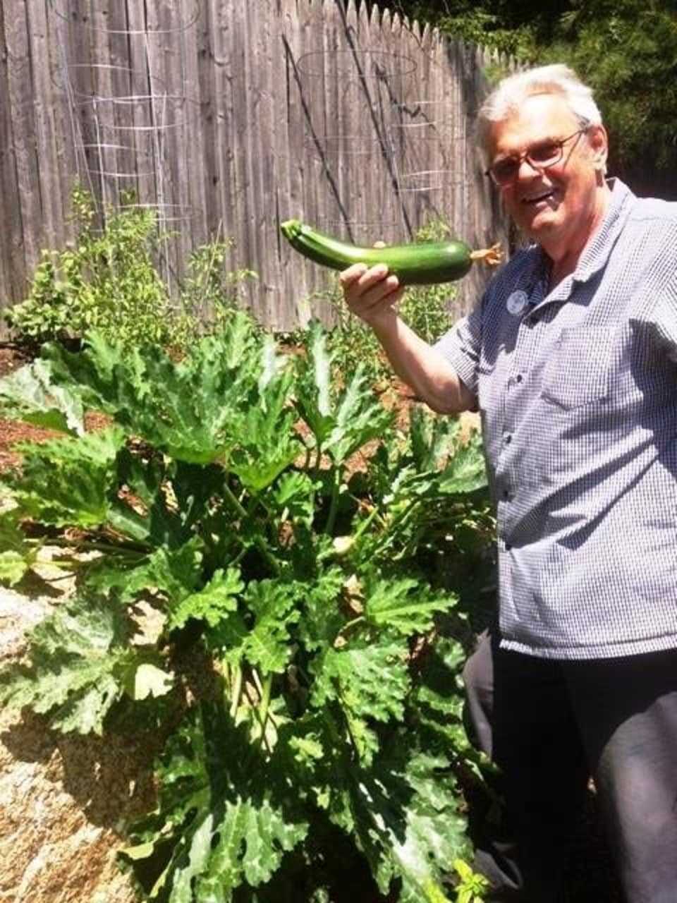 Bob Schlump holding some of the fruits of his farm.