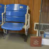 Mets memorabilia is visible in the front lobby of Mt. Kisco Glass. Pictured as a pair of seats from Shea Stadium and a replica donation brick of one displayed by Citi Field.