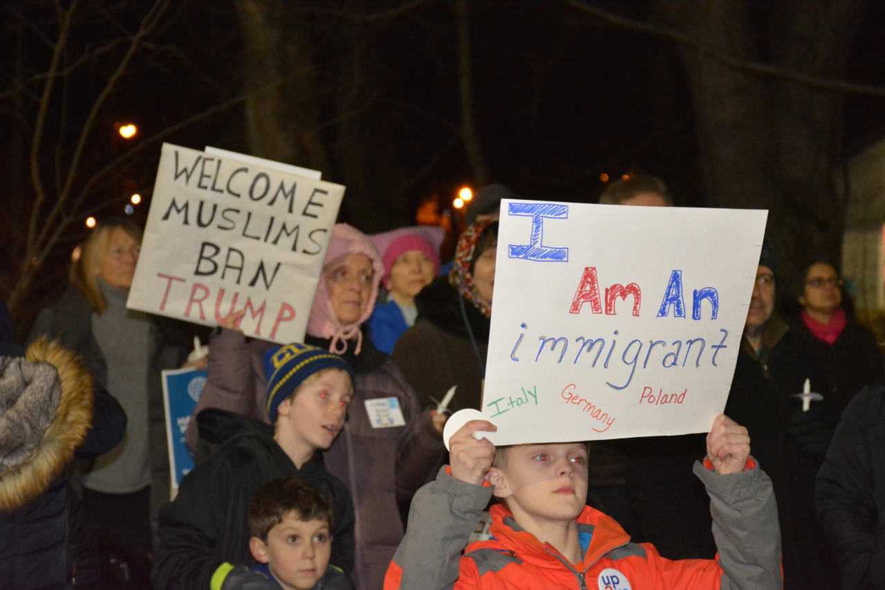 Demonstrators at an interfaith vigil in Chappaqua protest President Donald Trump's ban on admitting refugees.
