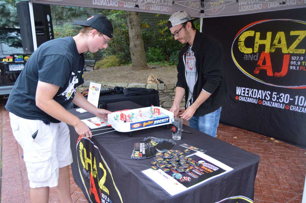 Chaz from the Chaz and AJ Show on 99.1-FM WPLR plays music and games at the Newtown event.