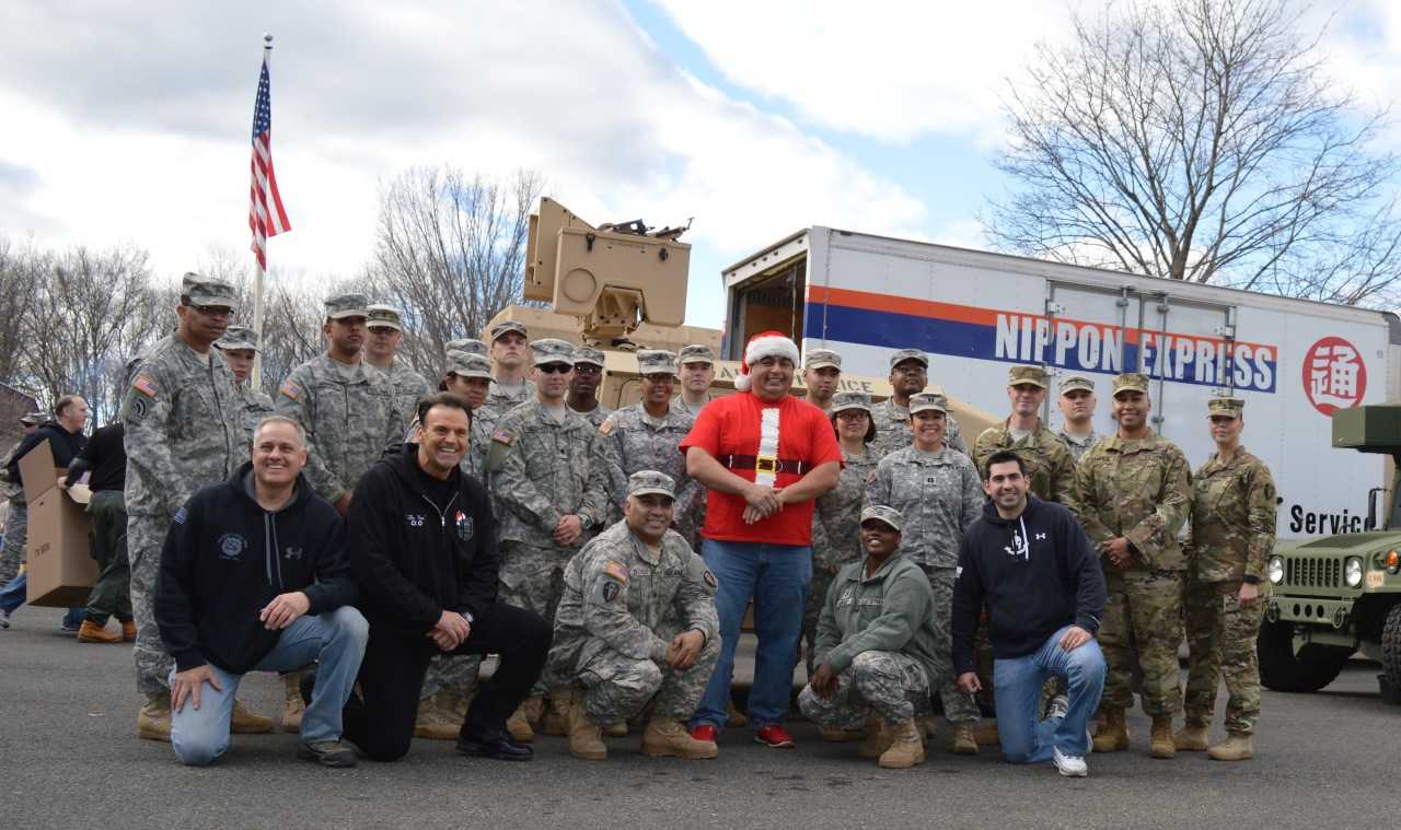 Former Closter Police Sgt. Don Nicoletti, bottom row, second from left, military members from the Teaneck Armory and friends break from sorting and loading.