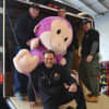 Don Nicoletti, bottom, and PBA members load a giant stuffed monkey into the Paramus Motorcycle Unit trailer.