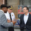 Harold Dimbo of Project Longevity, left, talks with Bridgeport Police Chief A.J. Perez and Mayor Joe Ganim.
