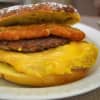 An honest-to-god sobo sandwich: egg, American cheese, a sausage patty, a hash brown patty, all served on a French toast bagel.