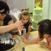 An instructor helps students in the Buttercup Bakery Camp.