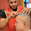 Stylist Vlady Garcia of New Milford works on a client at Cache Latino in Bergenfield. Garcia hails from Santo Domingo.