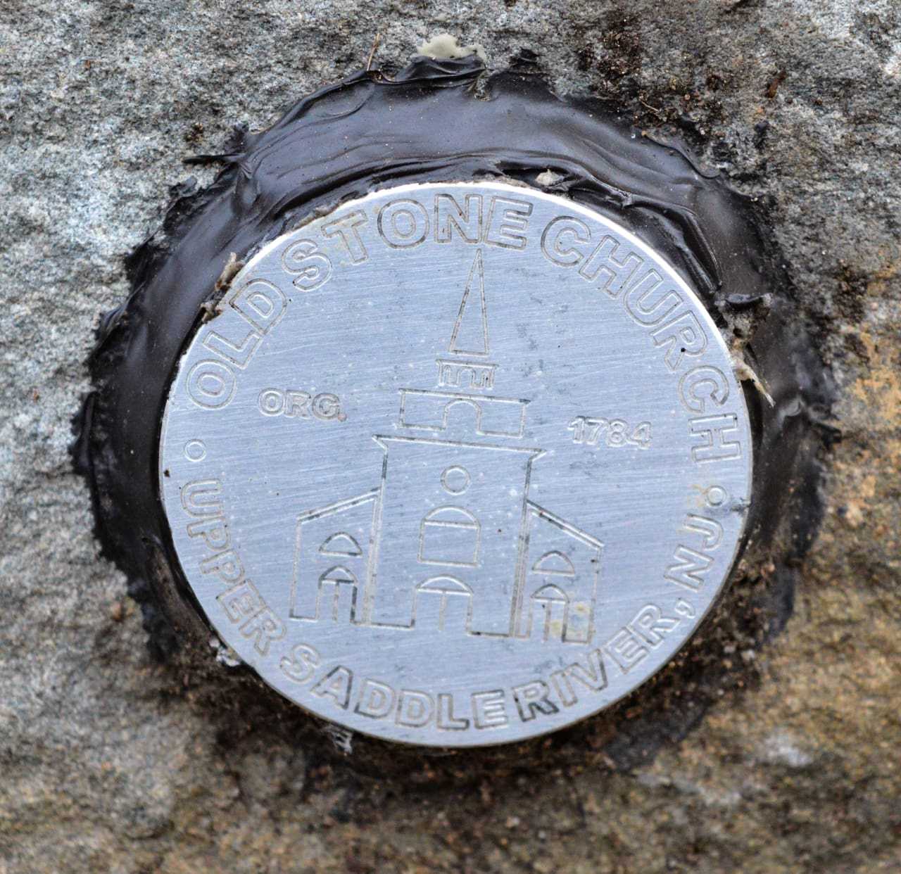 Some medallions bear the seal of the Old Stone Church.
