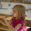 A young girl explores in the music room at Grace Farms. 