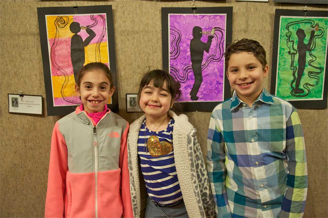 From left: Brooke Neigler, 8, Taylor Coroni, 7, and Blake Cortell, 7, stand in front of their work.