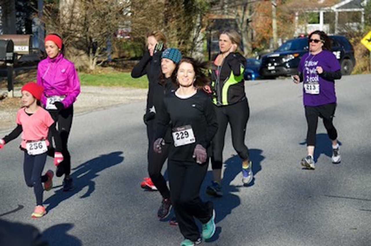 Runners and walkers young and old race to the finish line during the South Salem Turkey Trot 5K Run/Walk.