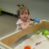 A girl plays in a sandbox at the Everwonder Children's Museum.