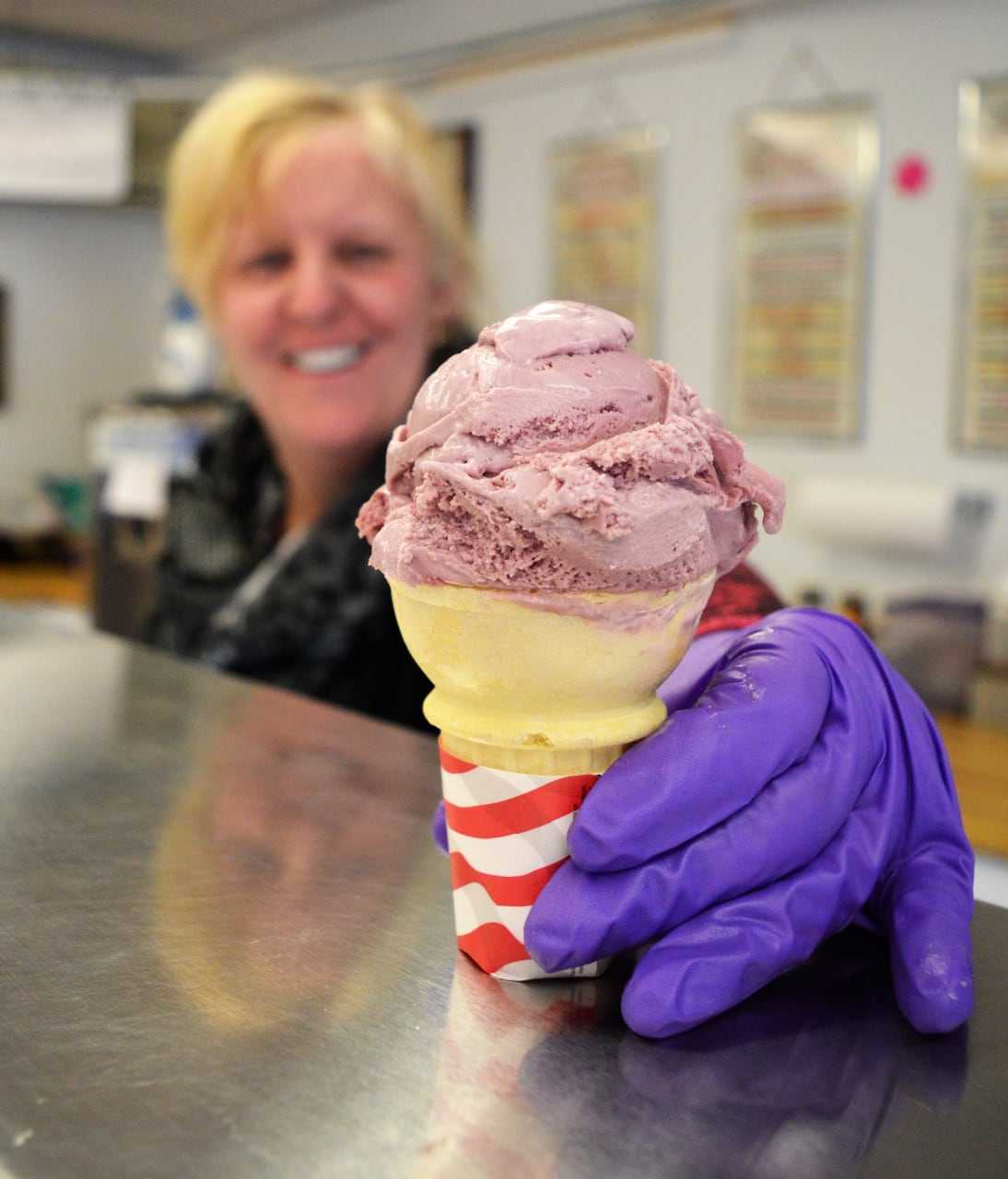 Theresa Brown of Clifton holds a cone of raspberry Nelson's Dutch Farms Ice Cream at the Whistle Stop.
