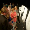 Guests at Friday's fundraiser look at plans for the Bedford Playhouse renovations.