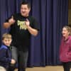 <p>Scott Luecke and Erin Luecke laugh with Danny Magic during one of his funny tricks.</p>