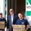 Daniel Weixeldorfer and employees from Ridgewood Moving help deliver food donations to Center for Food Action locations.