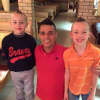 Nelson Guerra of Frank's Pizza in West Milford poses with a pair of young patrons.