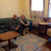 A married couple sits in their newly furnished home provided by Making-It-Home.