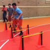 Athletes perform lateral jumps before partnering up at practice Monday.