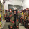 Erin, an au pair from Sweden, gets a laugh out of trying on gear at the South Salem Firehouse.