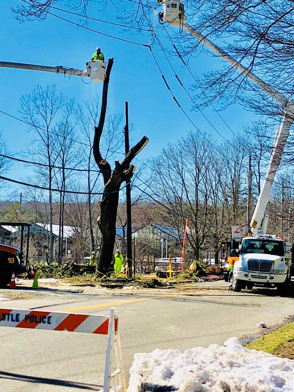 Utility crews trimming trees and restoring power lines along Bedford Road at Maple Avenue in Armonk.