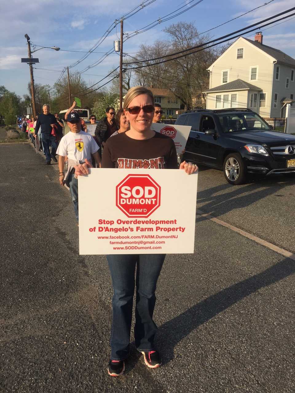 Dumont residents march in protest of the proposed redevelopment of the former D'Angelo Farms site.