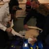 Volunteers learn how to use an Auto-Pulse, a device used to give compressions to patients automatically.