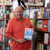 Kenny Sarfin, Owner of Books & Greetings, holds a book from one of this favorite authors, James Patterson.