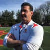 Bergen Catholic's lacrosse strength and conditioning coach Richard Robinson stands on the Crusaders' field.