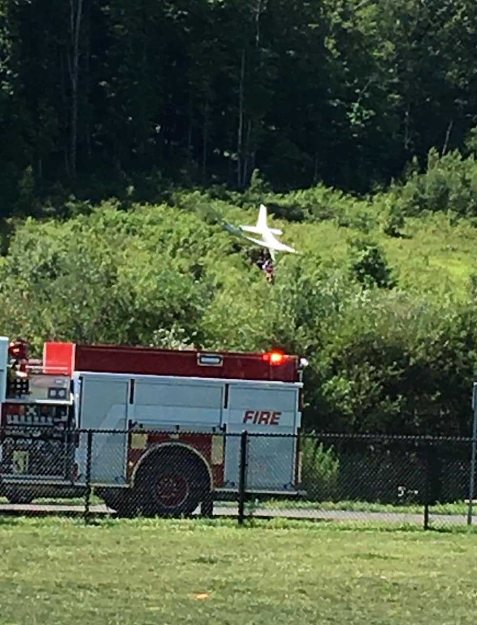 Fire and police are on the scene of plane crash on a hill above the dog park near the Danbury Airport on Sunday morning.