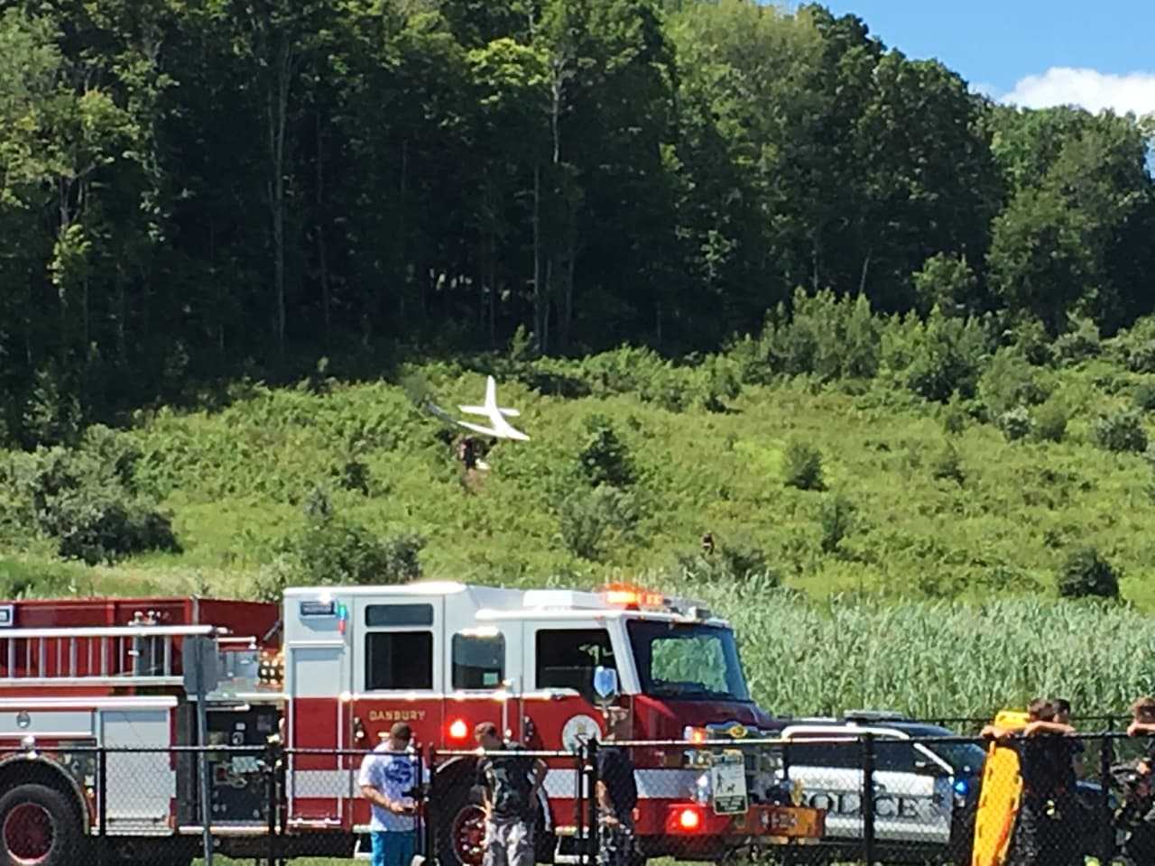 Fire and police are on the scene of plane crash on a hill above the dog park near the Danbury Airport on Sunday morning.