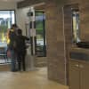 Big brother? A McDonald's employee assists a customer at the new automated kiosks in Thornwood -- aimed at speeding service. It took 12 steps to order one meal Monday, and even the worker confided "it's not customer-friendly."