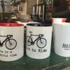Bike-themed mugs on display at Pacific Café in Stamford.