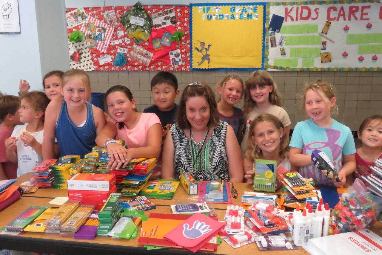 Janet Singer from the DCF in Bridgeport and Royle students with the school supplies they collected