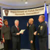 Norwalk Police Department officer Nate Paulino gets promoted to sergeant in a ceremony on Monday.