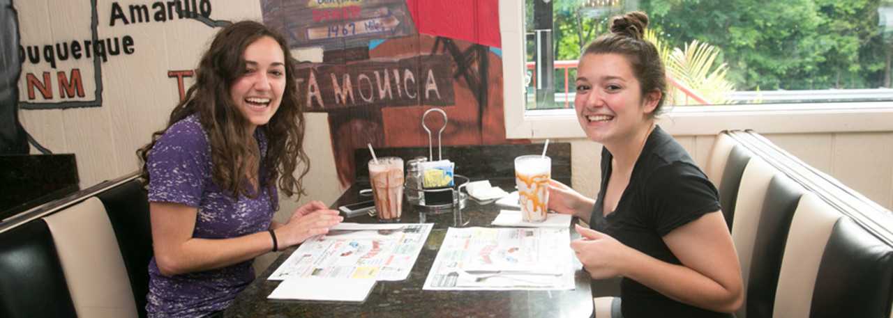 Customers peruse the extensive menu at the Oakland Diner.