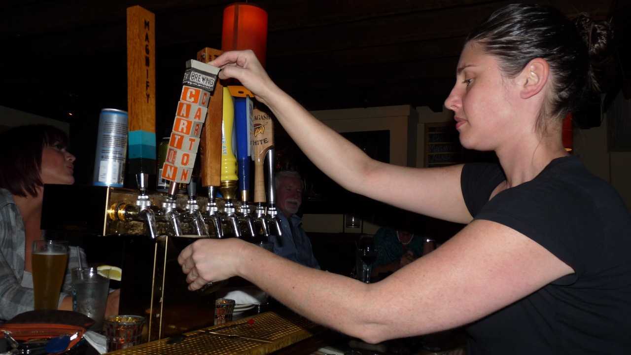 Twisted Elm Bartender Colleen Miller pulls a Carton of Milk, a milk stout from Jersey-based Carton brewery. 