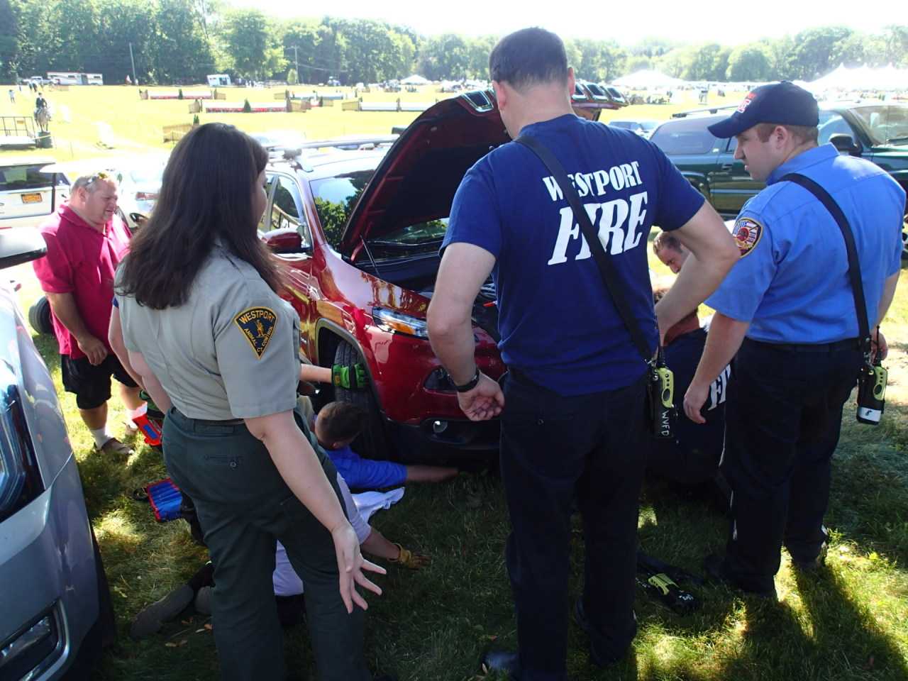 Westport Fire personnel work to free a kitten trapped in a car at the Fairfield County Hunt Club Horse Show Wednesday.