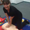 Randi Colton performing CPR on a mannequin.