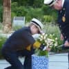 Former Ridgefield Fire Chief Heather Burford places flowers during a previous 9-11 memorial ceremony in town. 