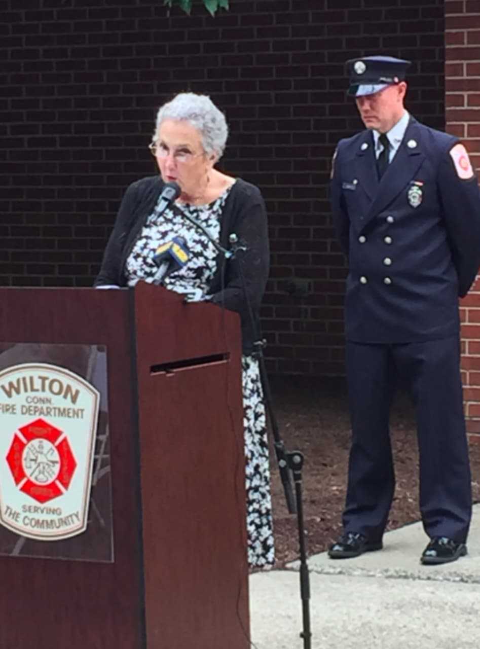 Wilton resident Sandy Mumbach speaks during the town's 9/11 ceremony. Behind her is Wilton Fire Department Lt. Jim Blanchfield.