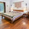 The bedroom features shimmering hardwood floors.