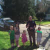Kids enjoy talking to Bethel Police Officer Michael McKinney while he drinks a cup of lemonade.