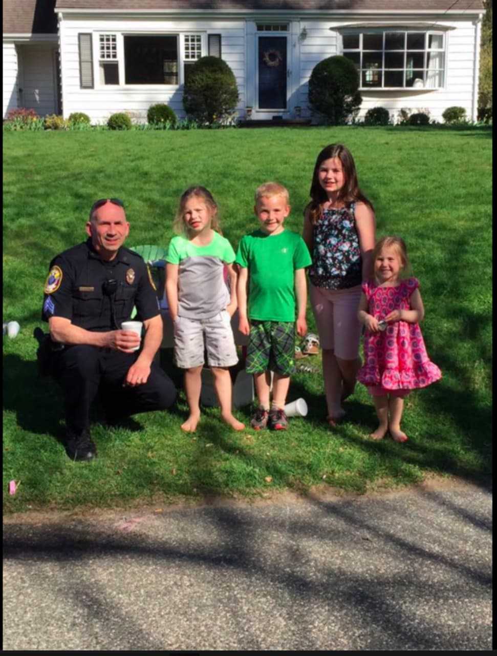 Bethel Police Officer Michael McKinney chats with kids on a recent warm evening.