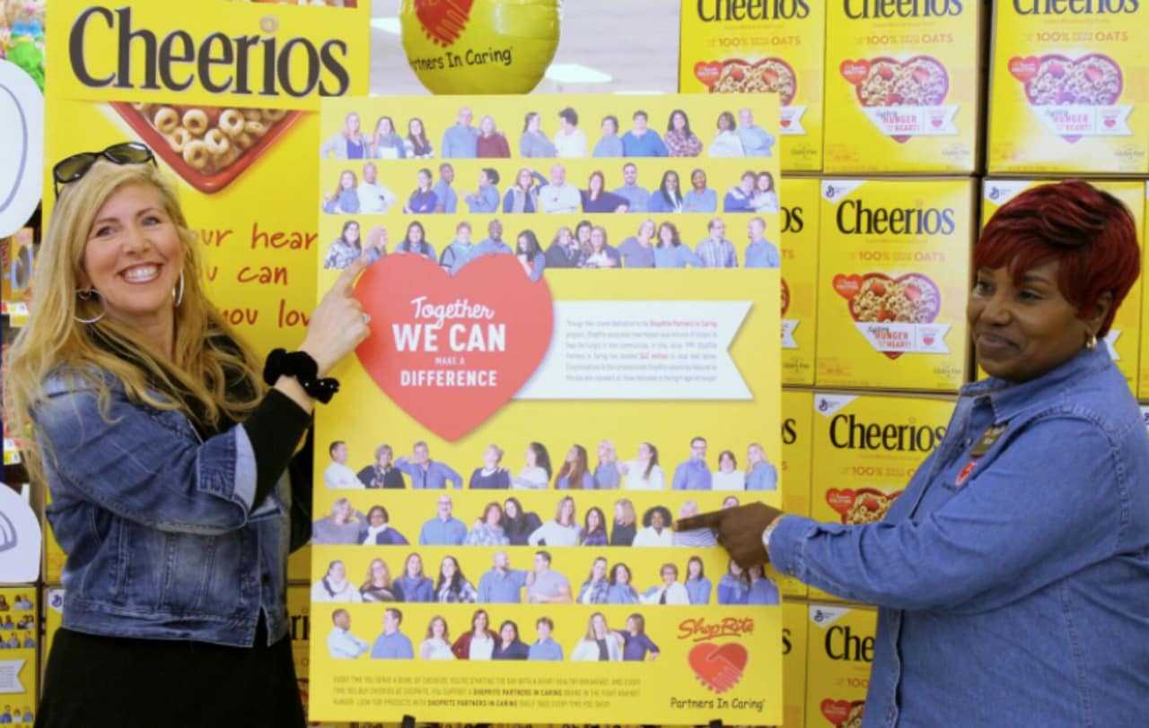 Croton ShopRite associates Sandra Puglielle, left, of Newburgh and Nora Bellamy of the Bronx point to their pictures on the special-edition Cheerios box featured now in ShopRite stores.