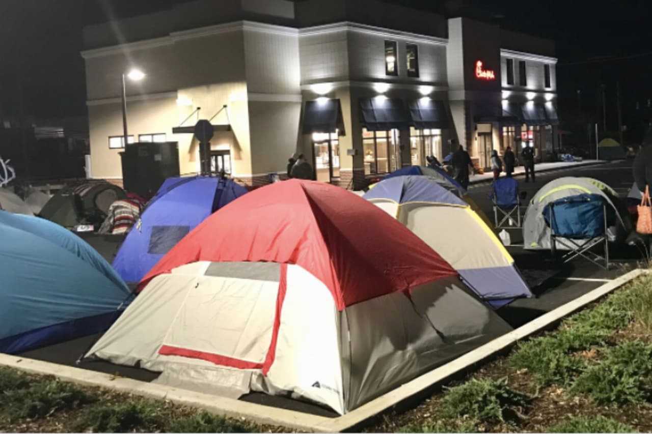 Dozens of people camp out overnight before the grand opening Thursday of the new Chick-Fil-A in Norwalk.