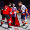 <p>Burgida, 11, drops the ceremonial first puck Friday for NJ Devil Brian Boyle and NY Islander Anders Lee.</p>